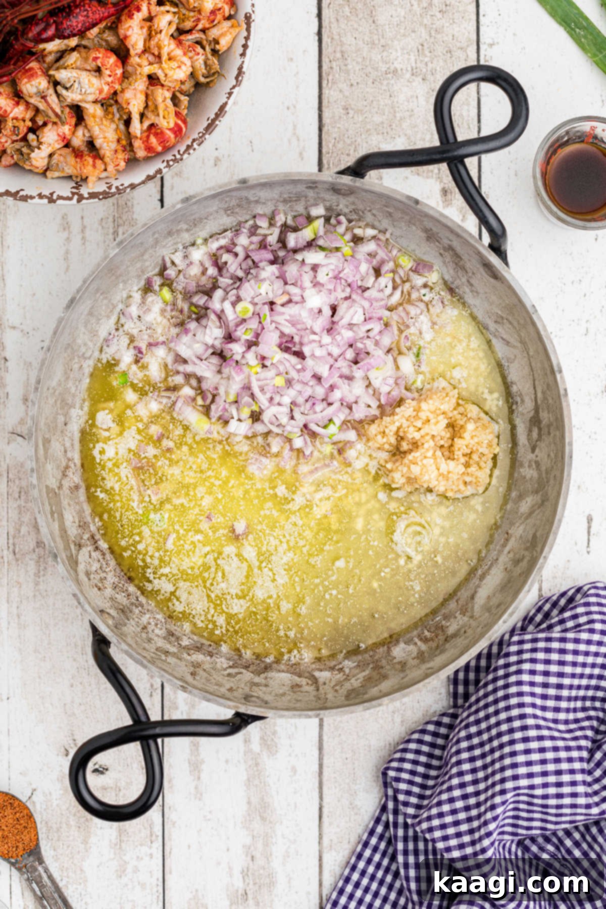 Creamy Cajun Crawfish Fettuccine 7 A skillet with melted butter, shallots, and garlic gently sautéing until translucent.