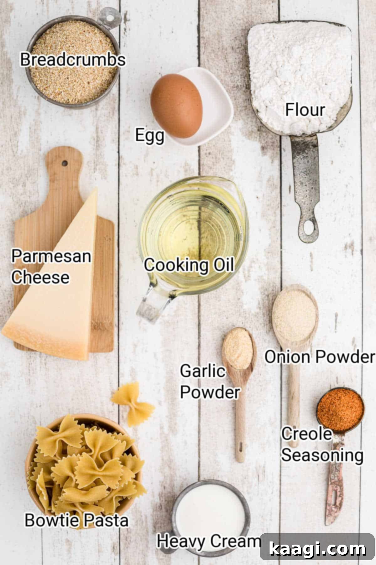 Crispy Farfalle Bites 3 A selection of ingredients meticulously laid out, including bowtie pasta, flour, spices, eggs, cream, breadcrumbs, parmesan cheese, and Creole seasoning, ready for preparing fried bowtie pasta.