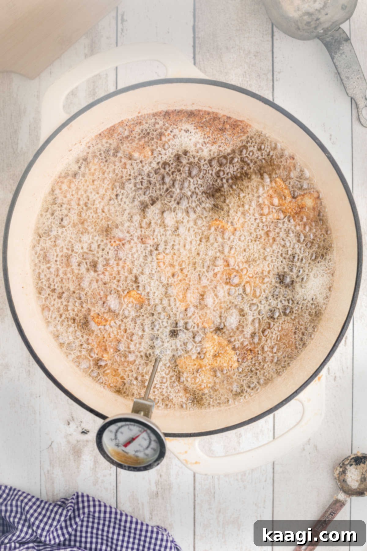 Crispy Farfalle Bites 9 A Dutch oven filled with hot oil, with a frying thermometer indicating 350°F, as batches of coated pasta are being deep-fried to a golden brown.