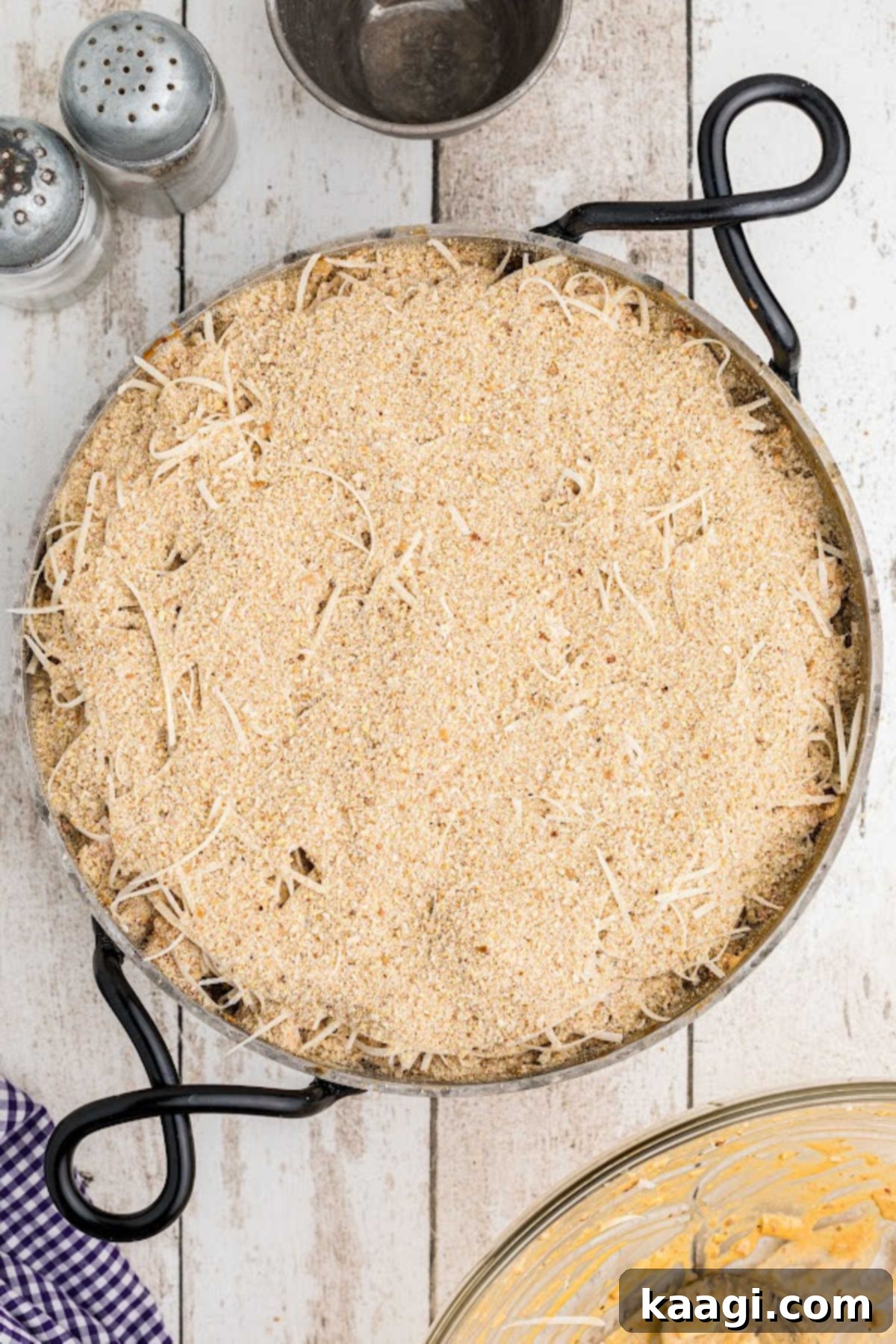 Breadcrumbs on top of a crawfish dip in a skillet.