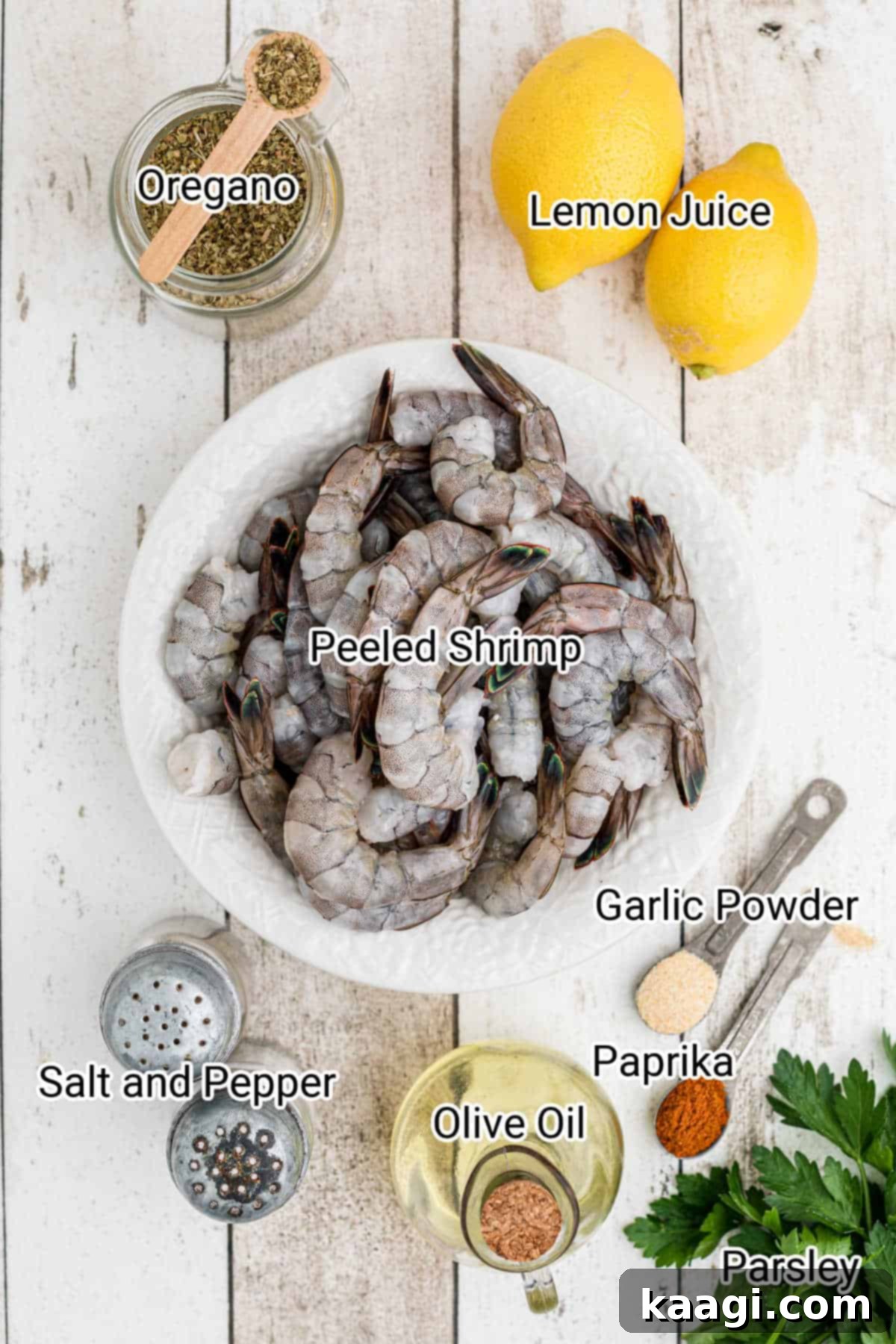A vibrant flat lay showcasing all the fresh ingredients needed for Texas Roadhouse grilled shrimp, including large shrimp, lemons, herbs, and spices.