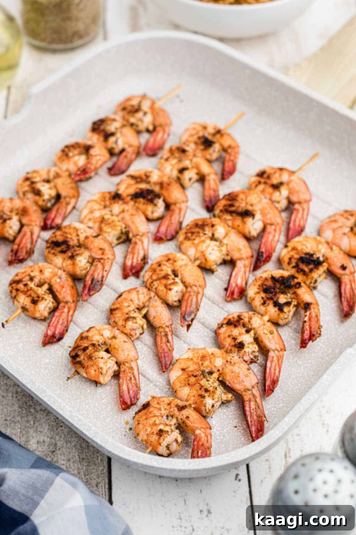Close-up of Texas Roadhouse grilled shrimp cooking on a grill pan, showcasing the beautiful sear and vibrant colors.