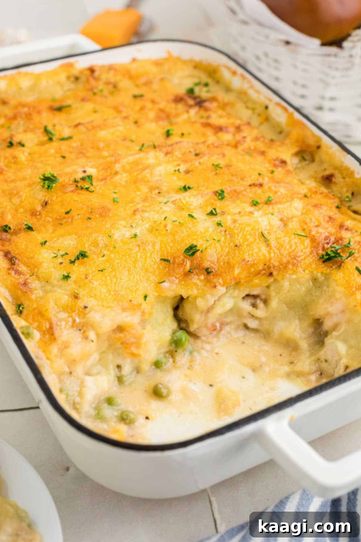 Side on shot of a dish of fish pie, with a scoop missing.