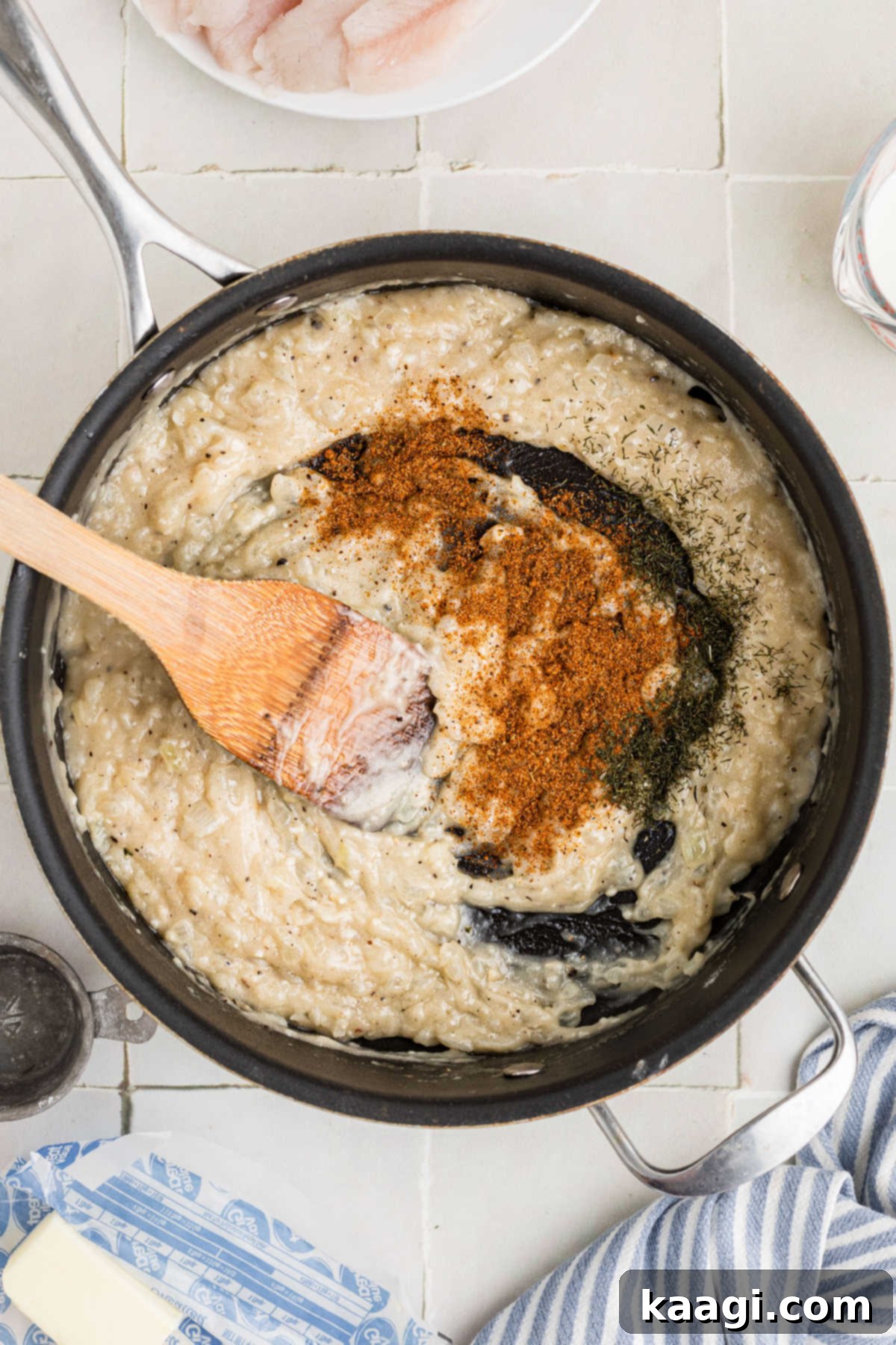 Seasonings sprinkled on top of a creamy mixture.