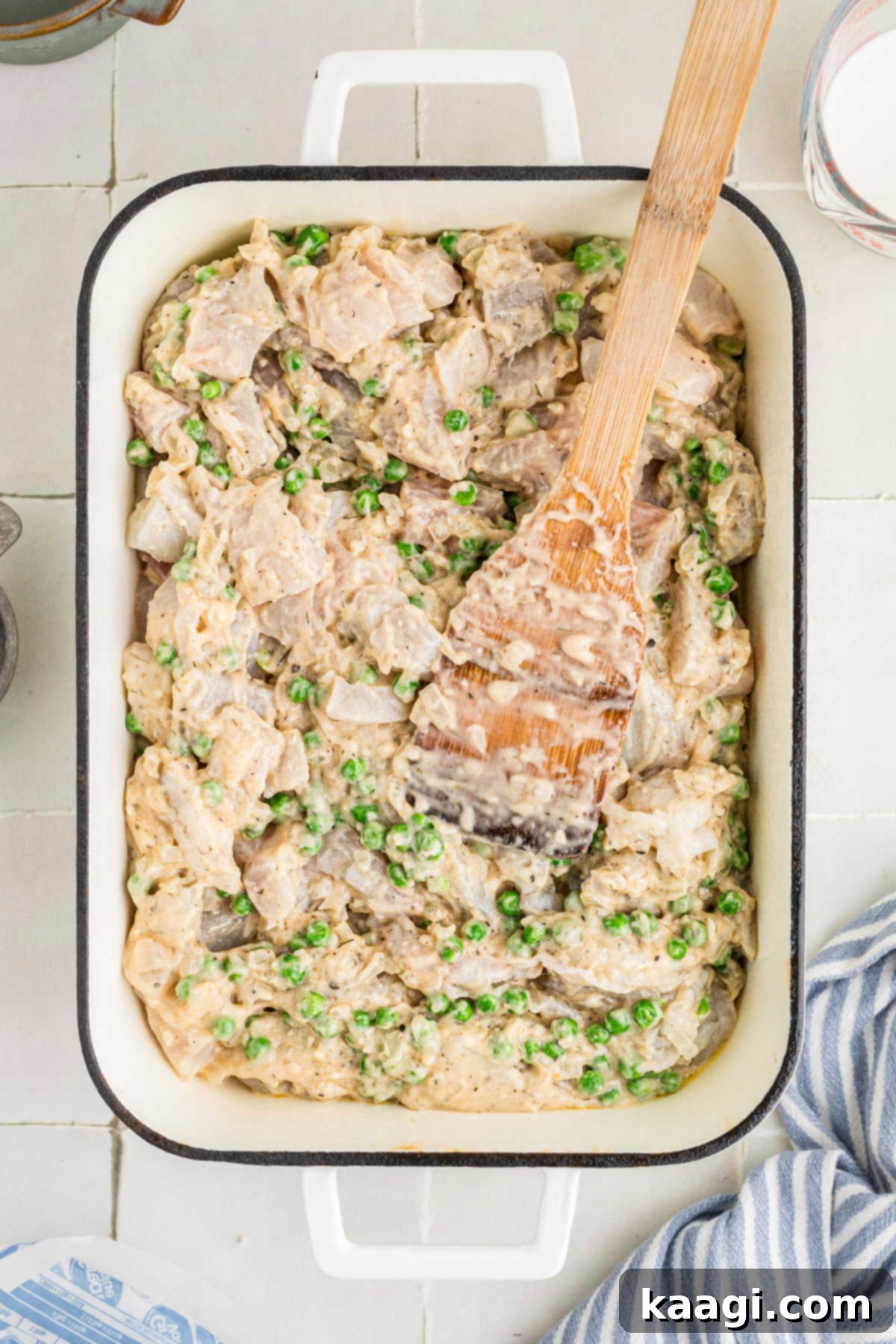 Fish and vegetable mixture added to a casserole dish.