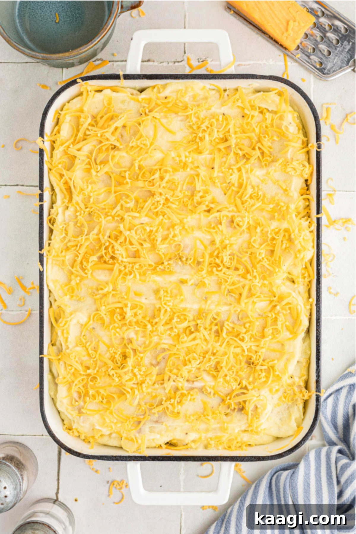 Grated cheddar cheese lightly sprinkled on top of mashed potatoes.