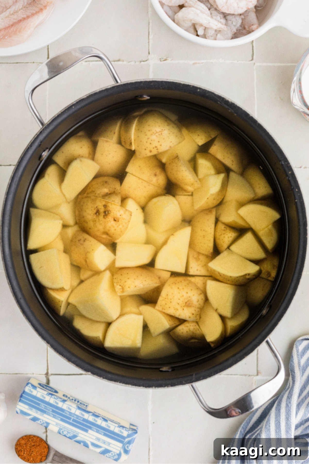 Potatoes cut and ready to boil in water.
