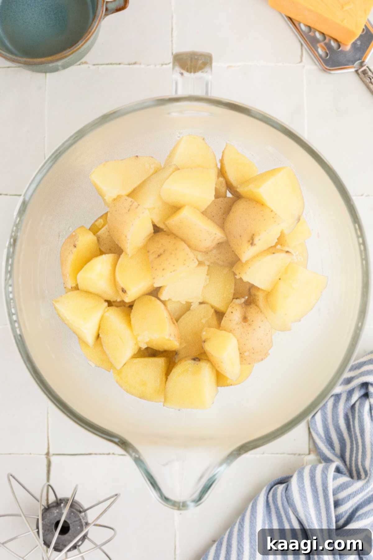 Cooked potatoes placed in a mixing bowl.