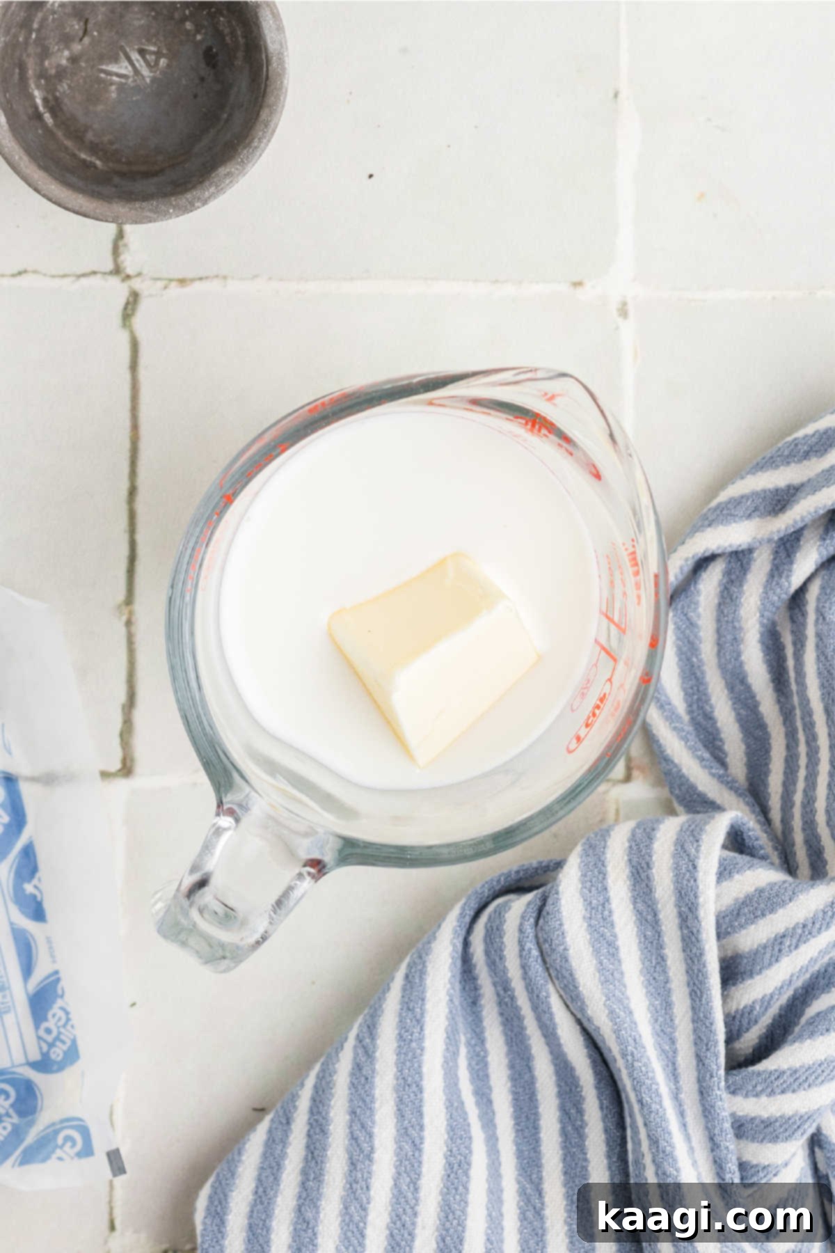 A measuring jug with milk and butter.
