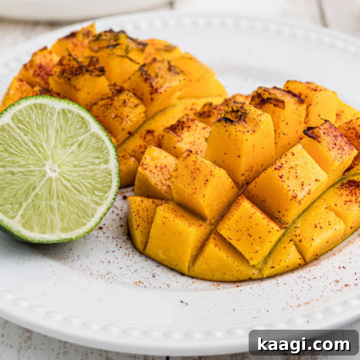 Southern Grilling Essentials 38 A plate with two pieces of grilled mango and a lime wedge, highlighting its sweet and spicy potential.