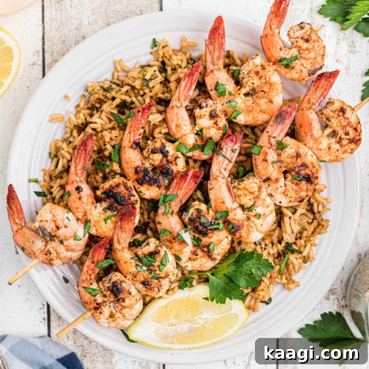 Southern Grilling Essentials 27 Overhead shot of Texas Roadhouse grilled shrimp skewers served over seasoned rice.