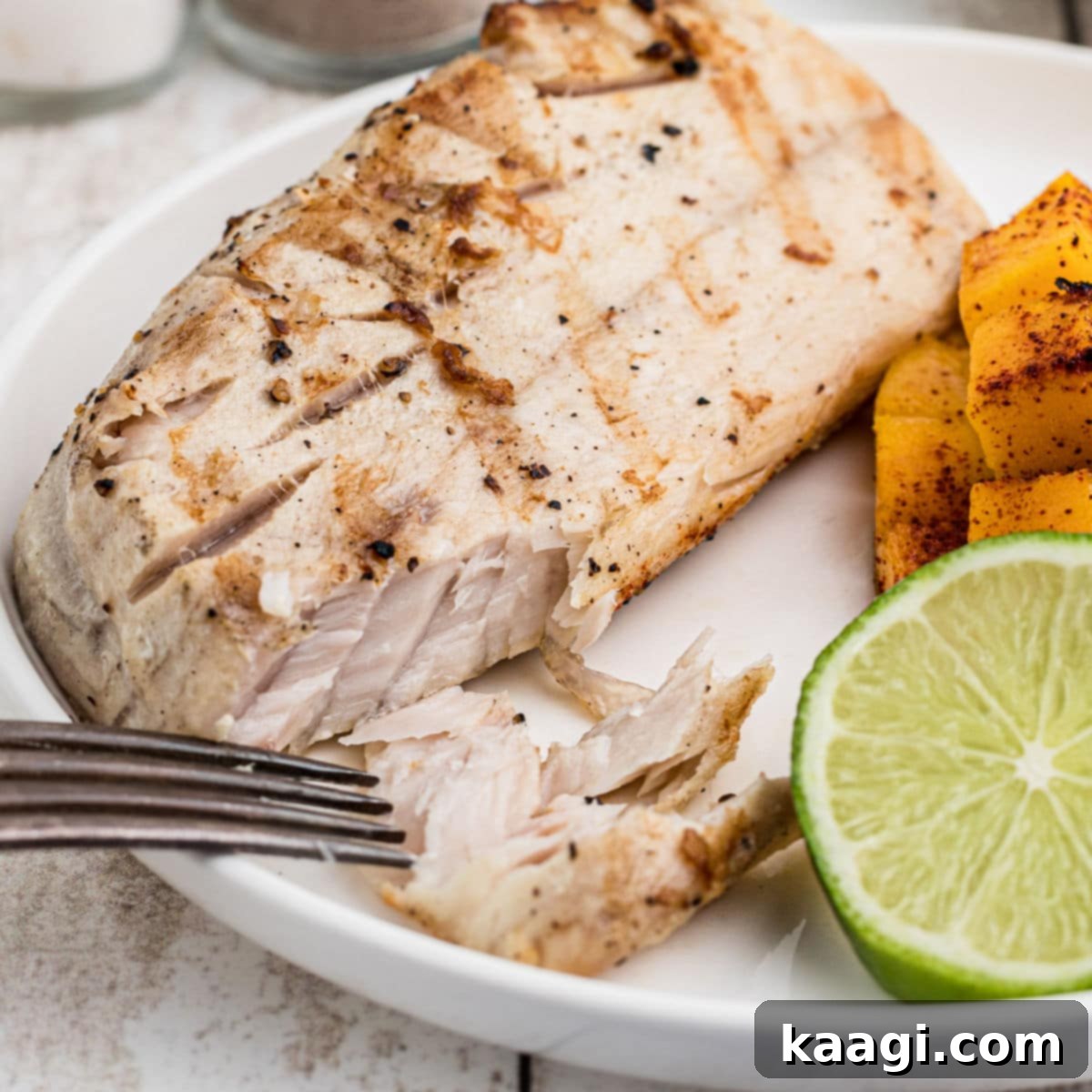 Southern Grilling Essentials 28 A close up of a fillet of Grilled Cobia with a fork digging in.