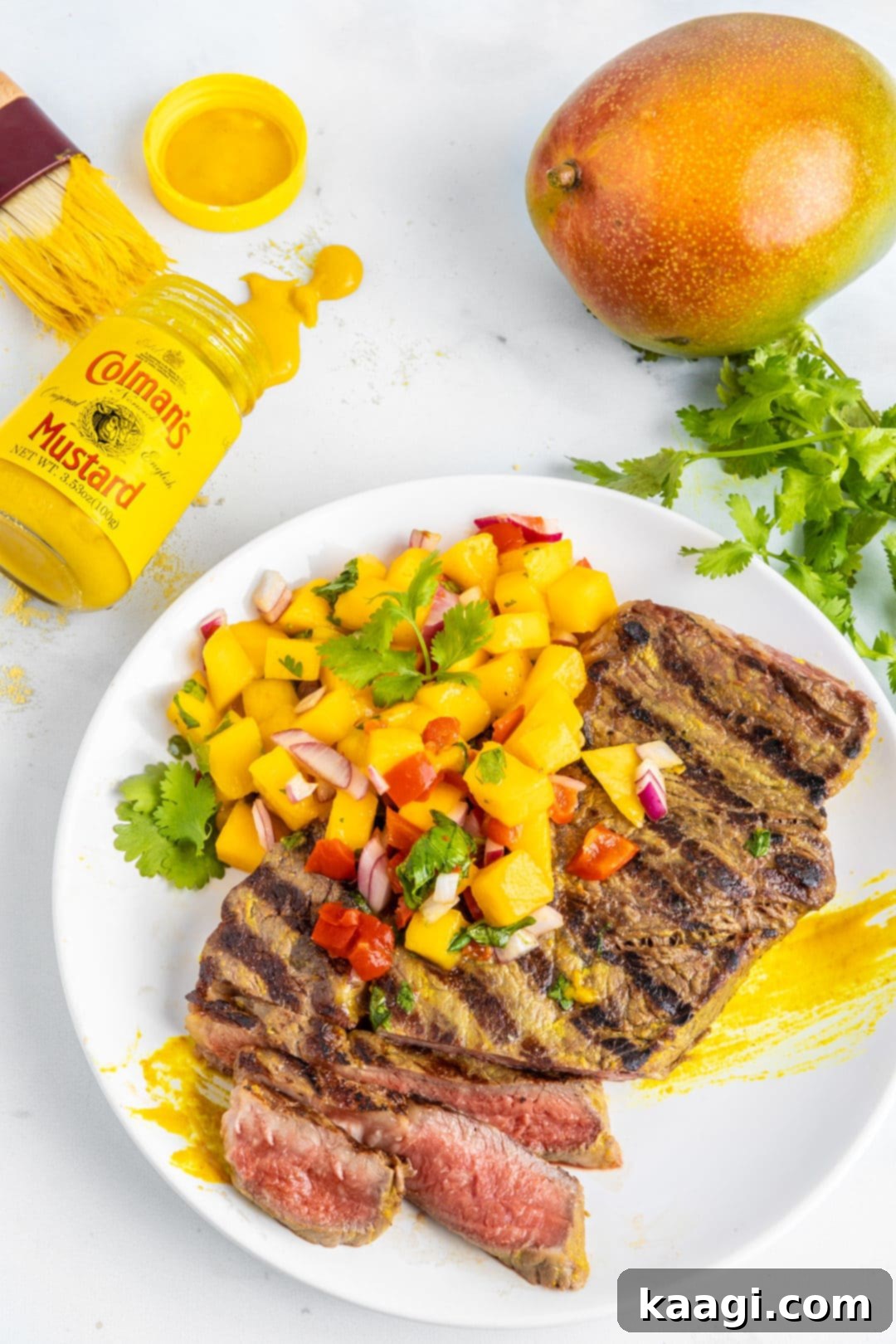 Southern Grilling Essentials 10 Grilled steak with a mustard crust, served with a vibrant mango salsa.