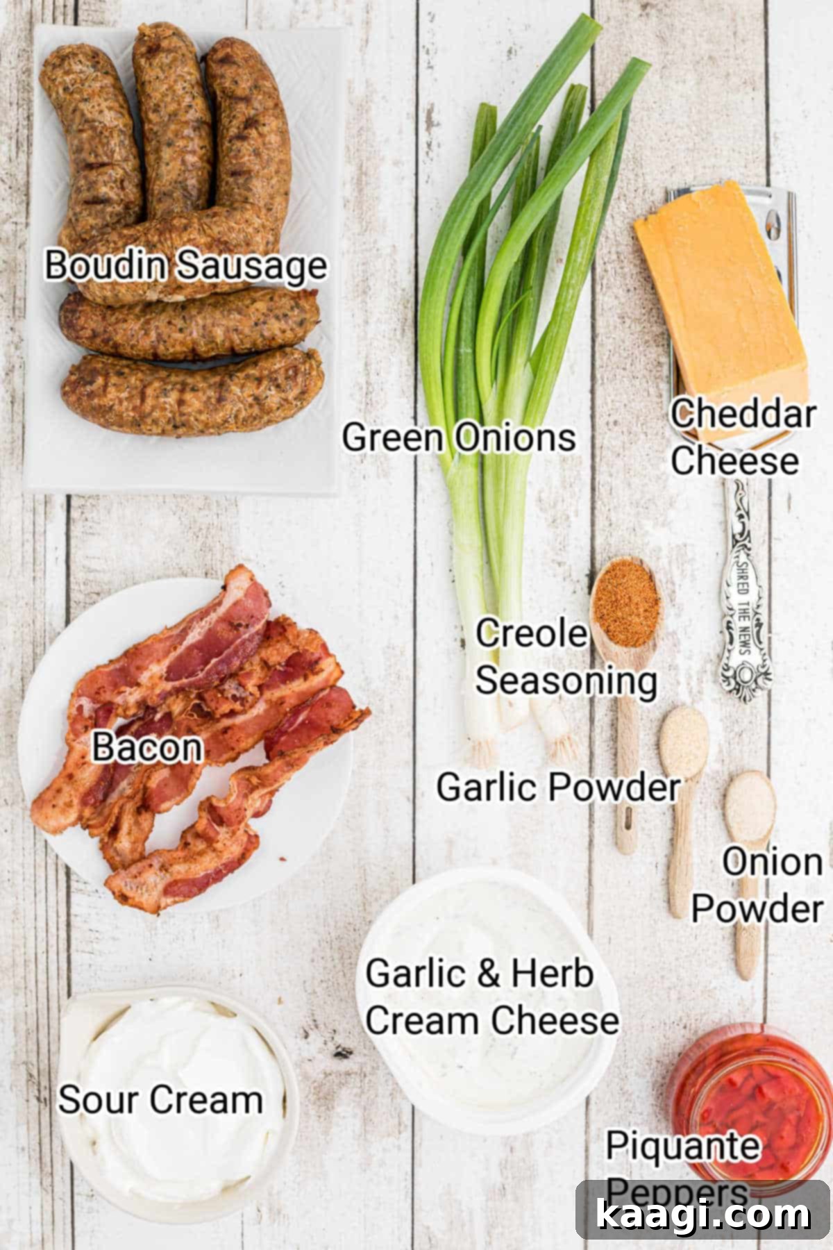 A neatly arranged flat lay of all the fresh ingredients required to make a delicious boudin dip, including boudin sausage, cheeses, sour cream, and spices.
