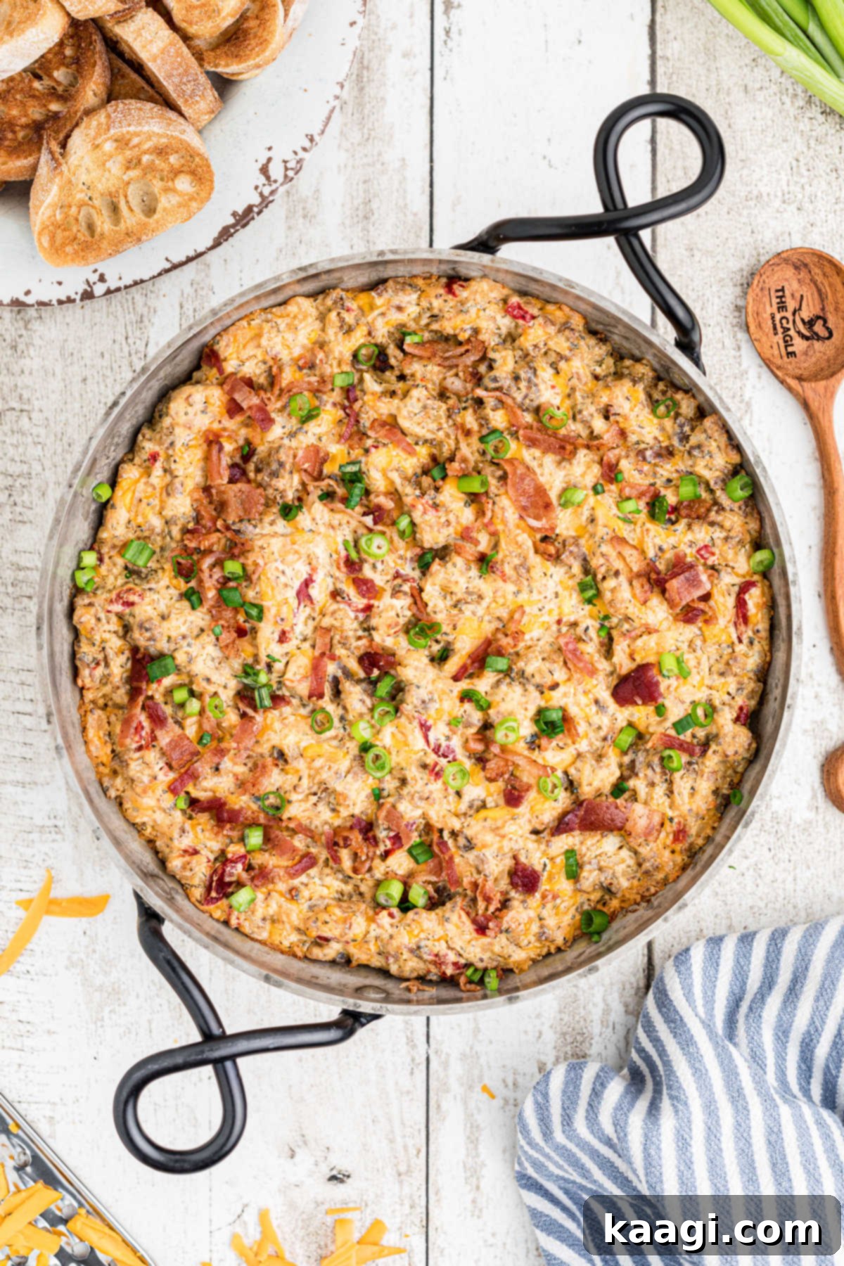 An overhead shot of a warm, bubbling boudin dip served in a rustic cast iron skillet, ready to be enjoyed.