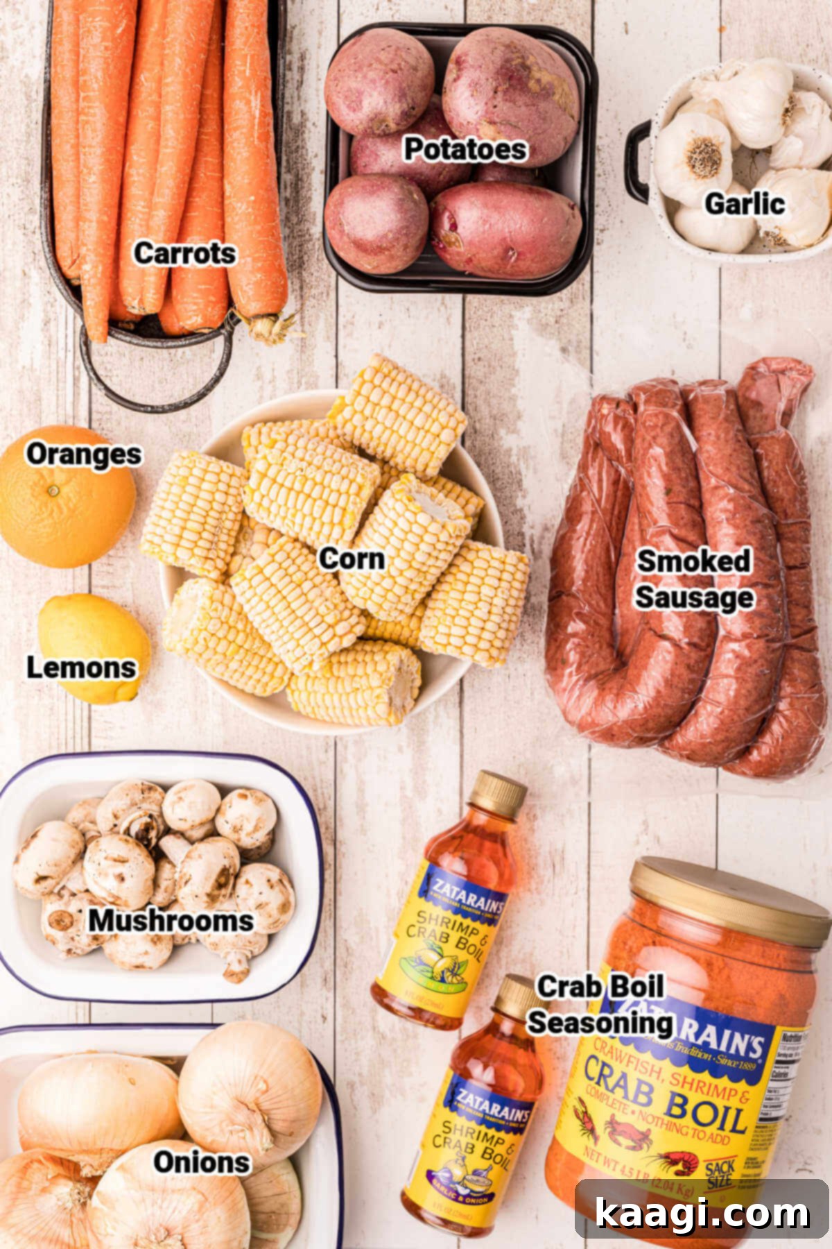 The Ultimate Crawfish Boil 3 A colorful array of fresh vegetables and seasoning bottles, including potatoes, onions, garlic, carrots, corn, mushrooms, oranges, and lemons, laid out as ingredients for a crawfish boil.