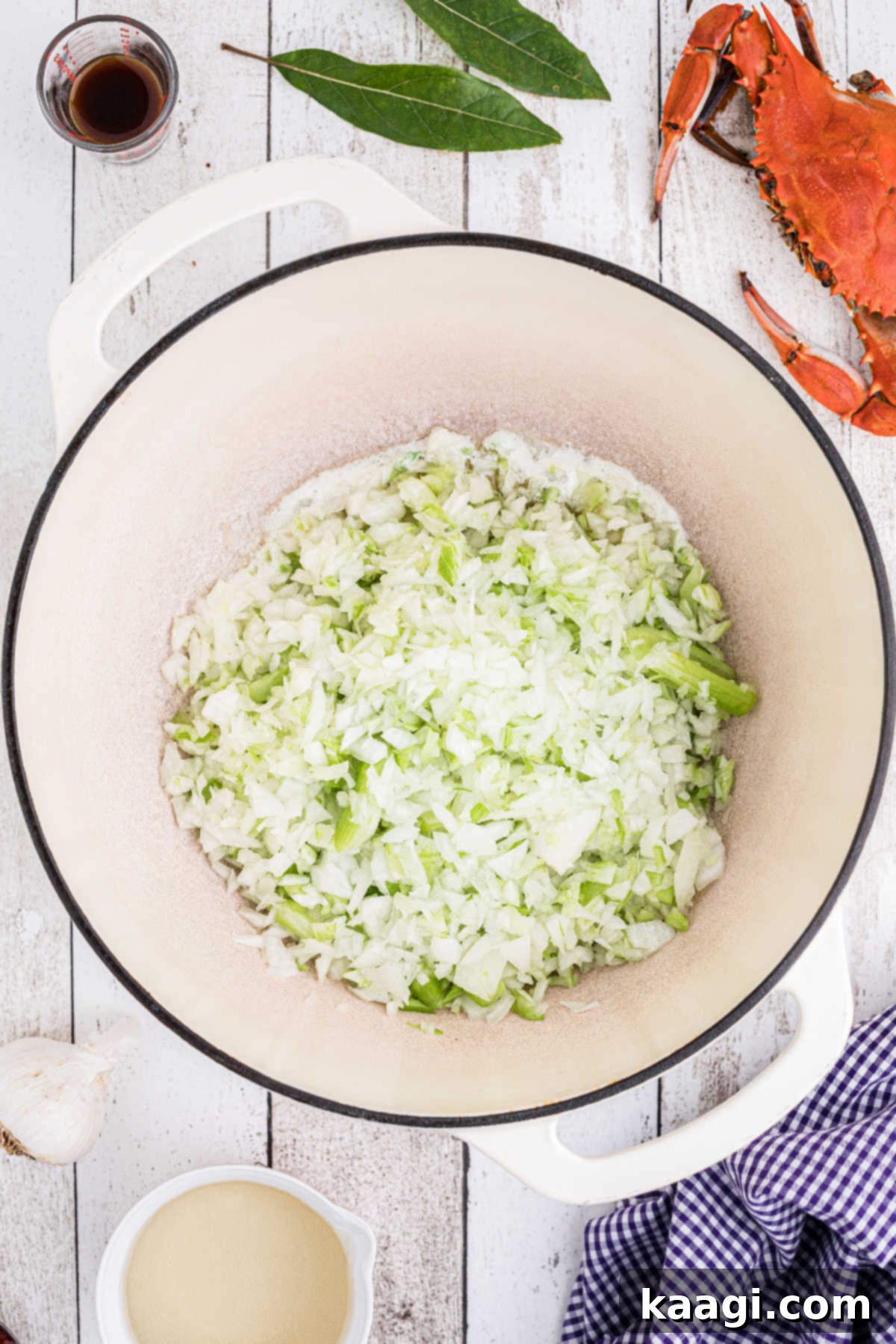Diced vegetables added to a large Dutch oven.