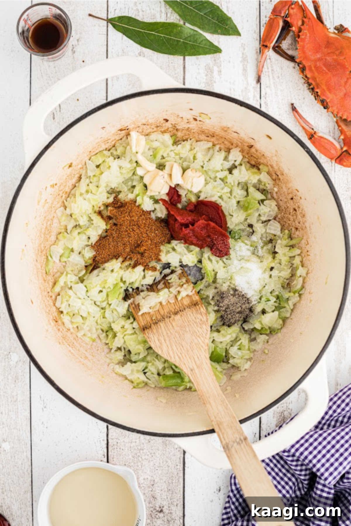 A few different seasonings added to a pot with cooked onions and peppers.