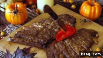 Barbecue ribs arranged to look like a gruesome severed arm, decorated with red pepper for a spooky effect.