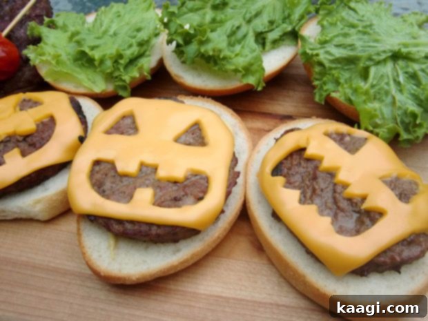 Halloween-themed cheeseburgers with faces carved into the cheese to resemble Jack-O-Lanterns.