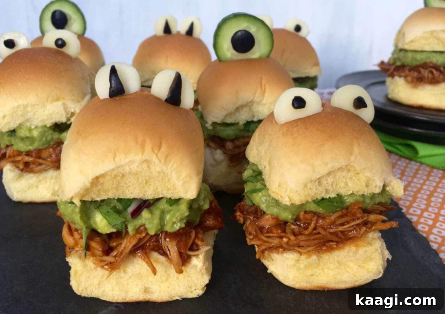 Chicken sliders decorated with black olives to resemble monster eyeballs.