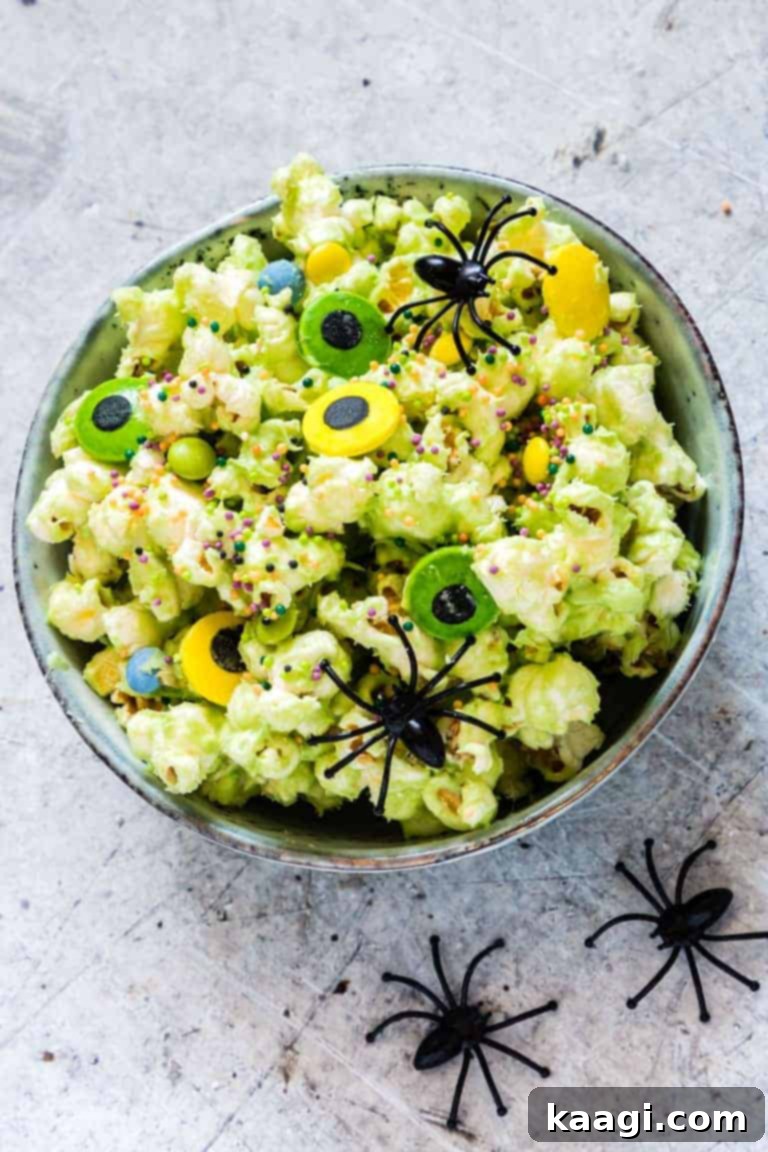 Monster Halloween Popcorn with candy eyes and plastic spiders.