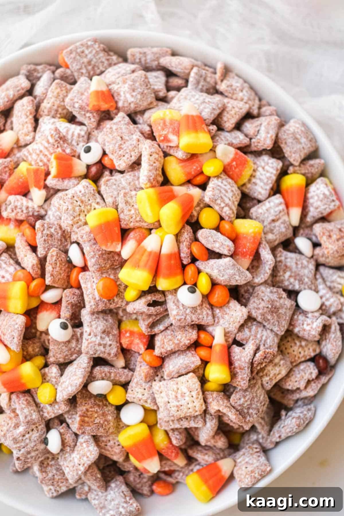 Halloween themed Puppy Chow with colorful candies.