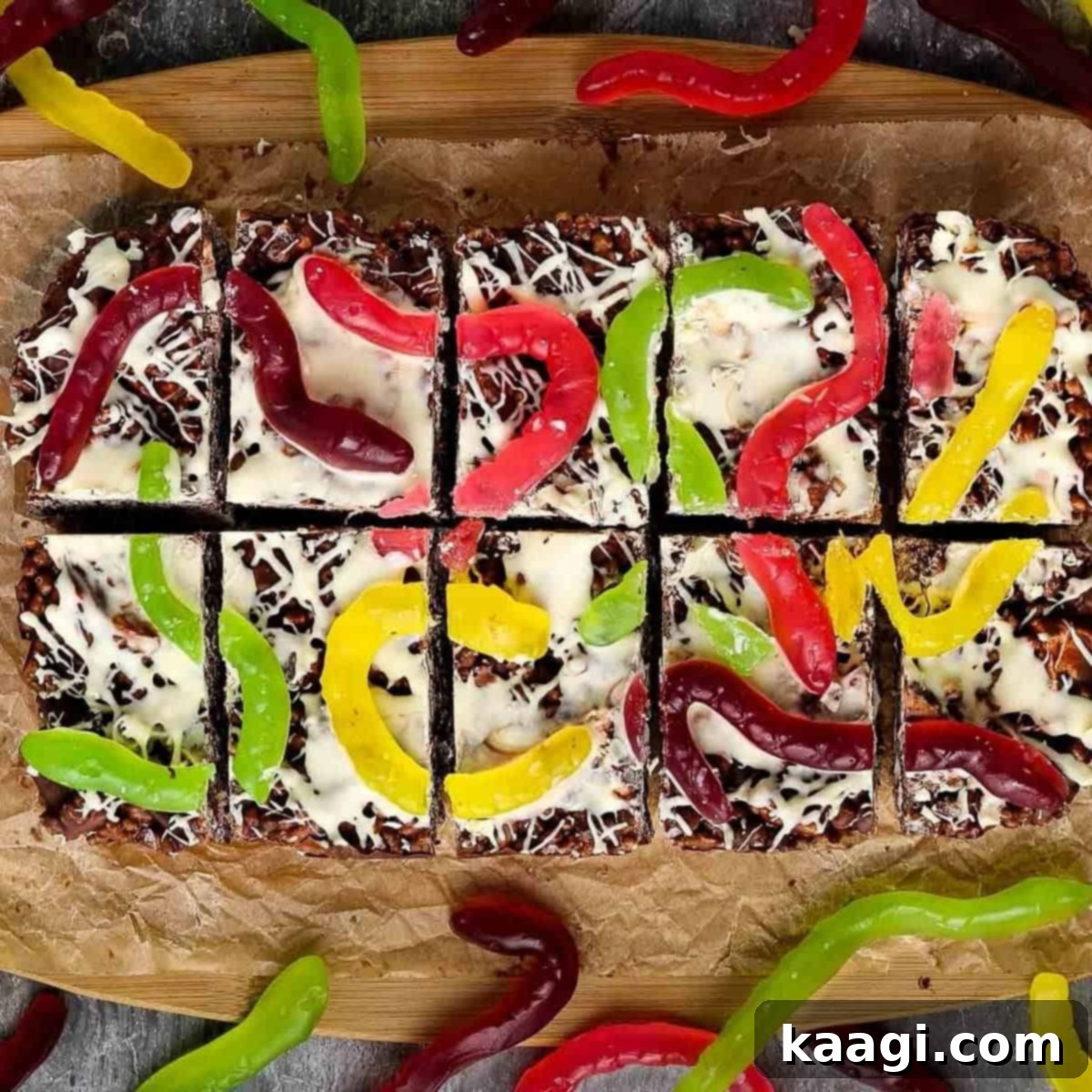 Halloween Rocky Road dessert with snake lollies and spiderweb design.