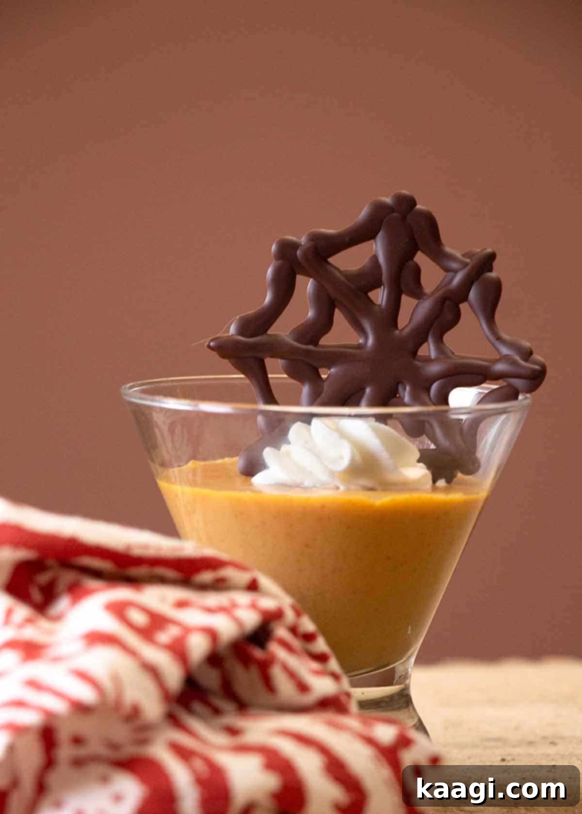 Pumpkin pudding with chocolate spider webs.