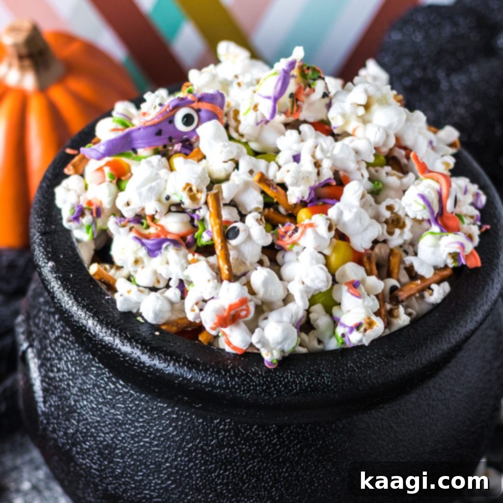 Halloween Monster Munch Popcorn Mix with pretzels and colorful candy melts.