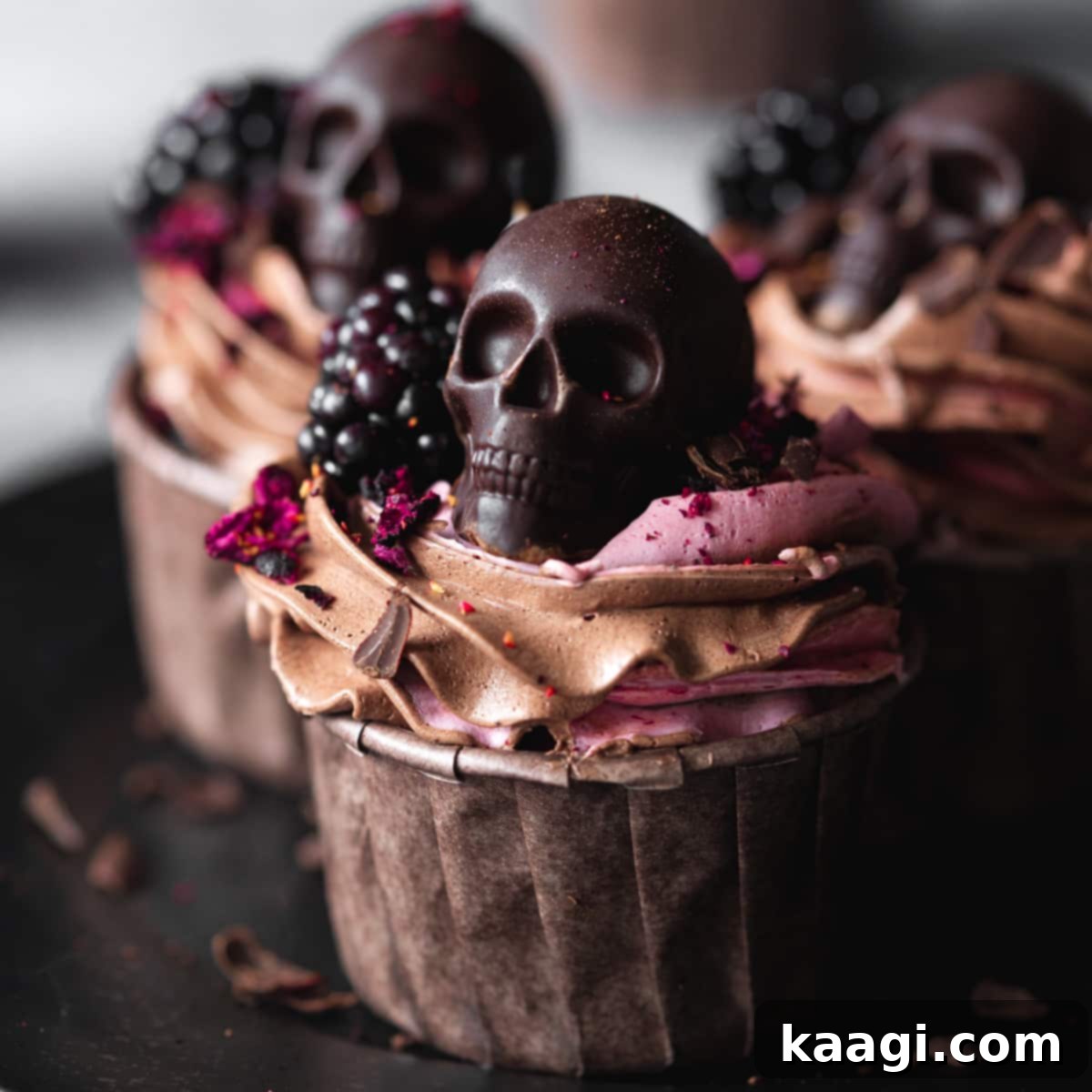 Vegan Blackberry Chocolate Cupcakes topped with chocolate skulls.