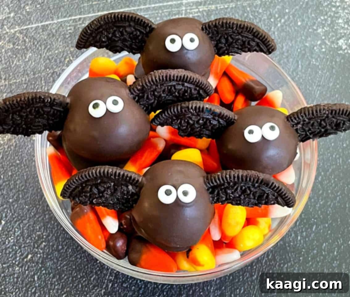 Cute bat-looking cake pops in a bowl of candy.