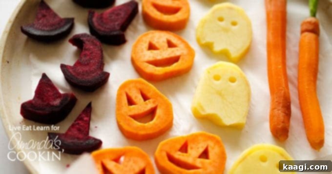 Roasted Halloween Vegetables shaped like jack-o-lanterns and ghosts.