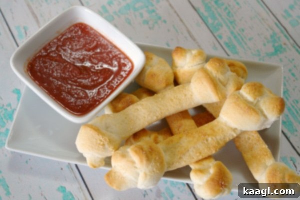 Fun and Easy Breadstick Bones served with marinara sauce.