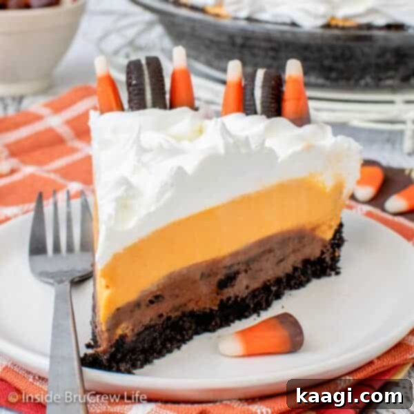 A festive Halloween-themed pie, likely an Oreo cream pie, adorned with colorful sprinkles and candy corn.