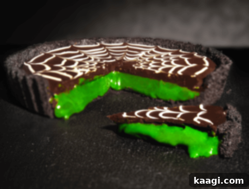 A bright green 'slime' Halloween pie, possibly with a chocolate or caramel base, looking gooey and fun.
