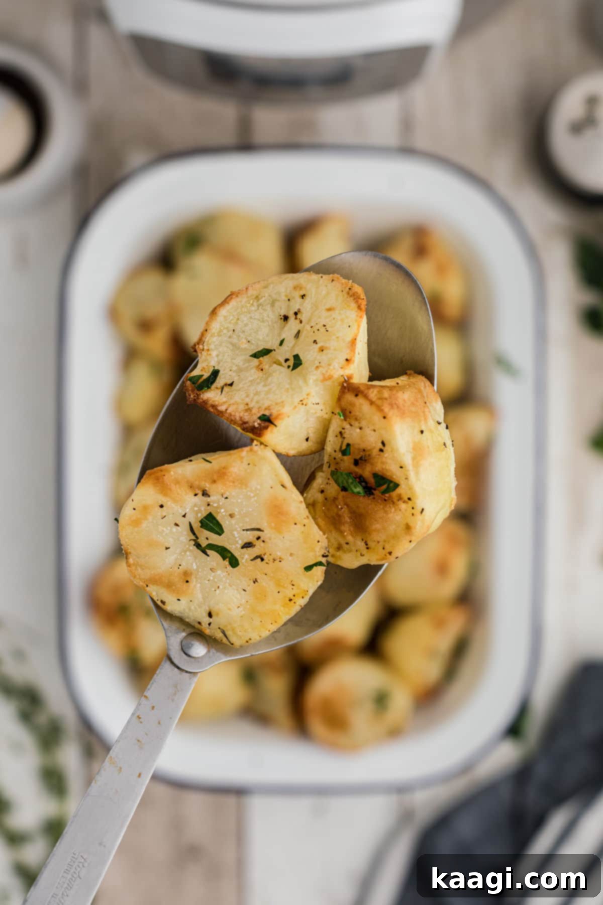 Pressure-Perfect Crispy Spuds 11 a spoon with three crispy instant pot potatoes on it