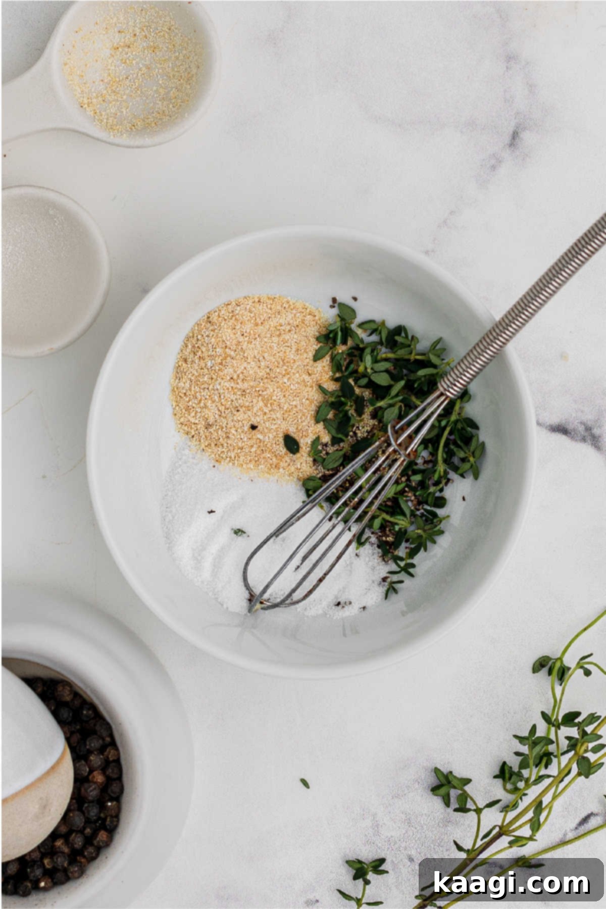 Pressure-Perfect Crispy Spuds 9 Seasonings in a mixing bowl, with a small whisk.