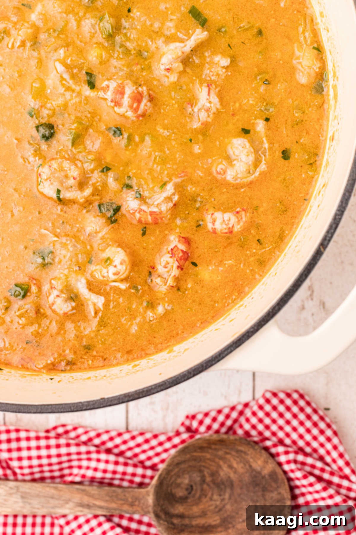 a close up of a pot full of crawfish etouffee with obvious crawfish tails on top