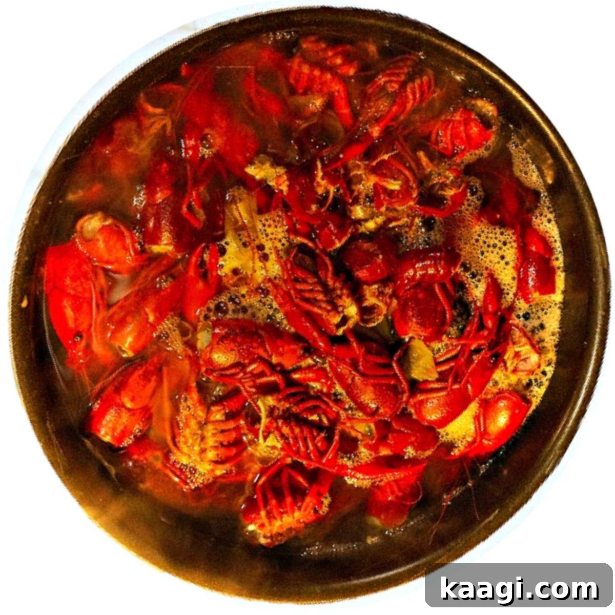 A stock pot full of crawfish tails and heads making a crawifsh stock.