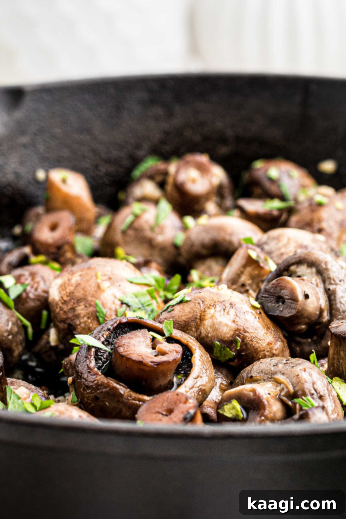Wood-Kissed Mushrooms 2 Close up from the side of some smoked mushrooms in a cast iron pot, showcasing their rich, buttery texture and smoky appeal.