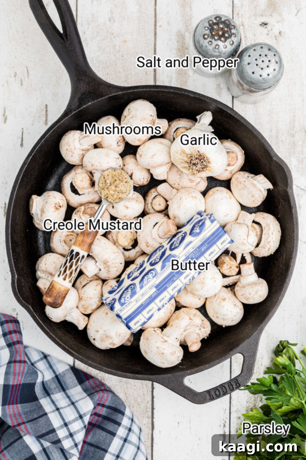 Wood-Kissed Mushrooms 3 Overhead shot of a cast iron pot full of fresh mushrooms with a stick of butter and garlic cloves, ready for smoking.