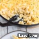 close up of a skillet of mac and cheese with some missing.