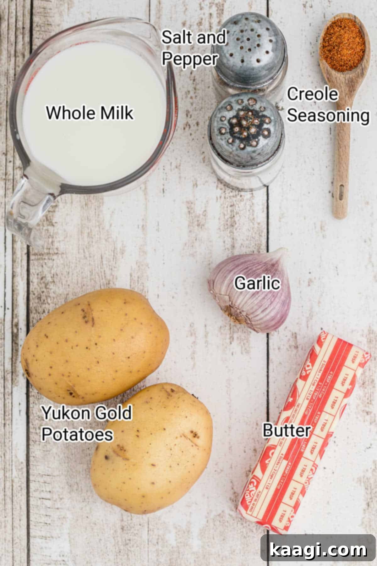 Popeyes mashed potatoes ingredients laid out on a kitchen counter, including potatoes, garlic, butter, and milk.