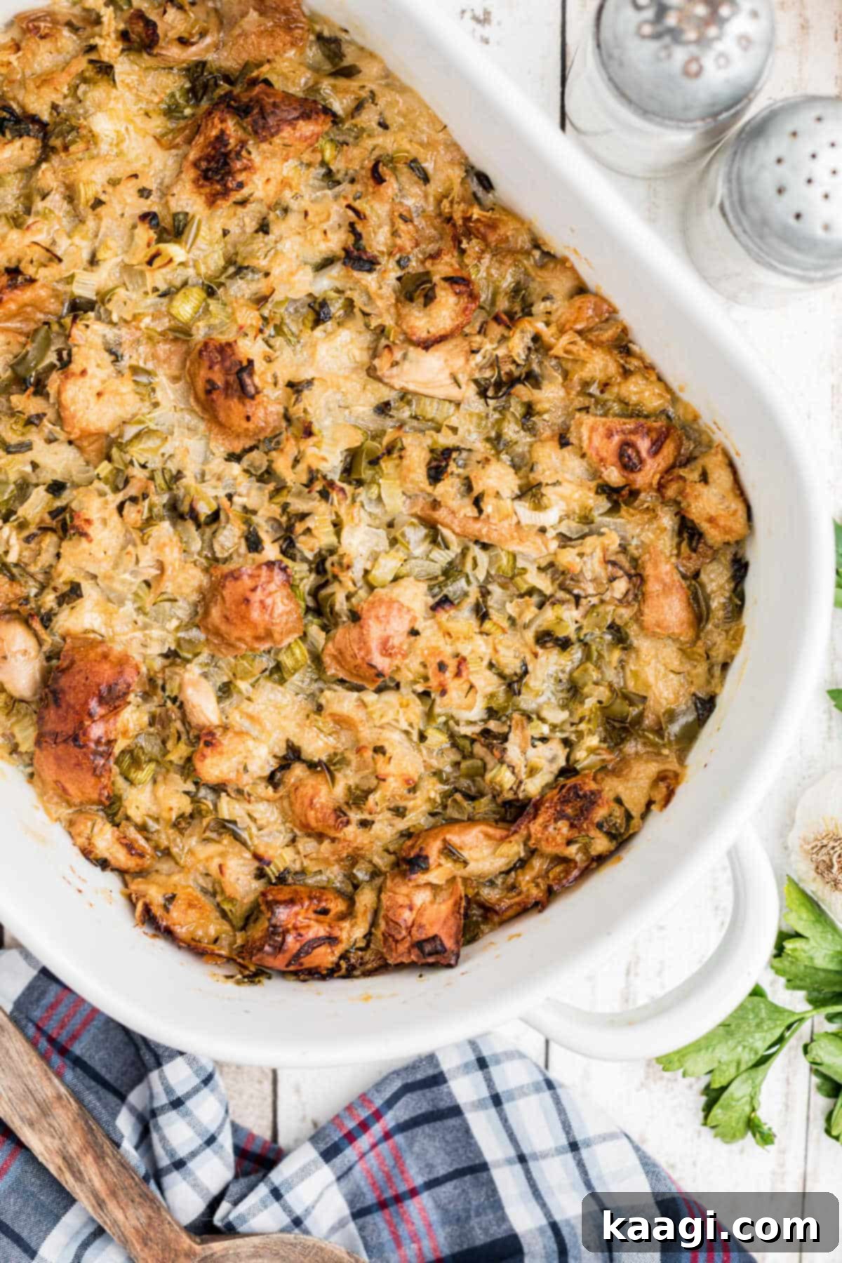 Overhead shot of a golden-brown baked oyster dressing in a rustic casserole dish, ready to be served.