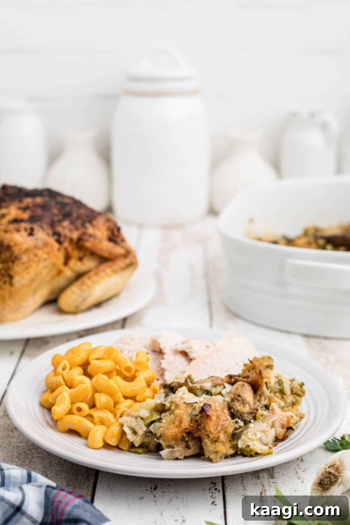 A festive plate of Thanksgiving food, prominently featuring a generous serving of southern Oyster Dressing in the foreground.