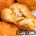 Crispy Air Fryer Mac & Cheese Poppers 11 Overhead and close up shot of the inside of a mac and cheese bite, showing the gooey Velveeta and bacon center, with a golden-brown crust.