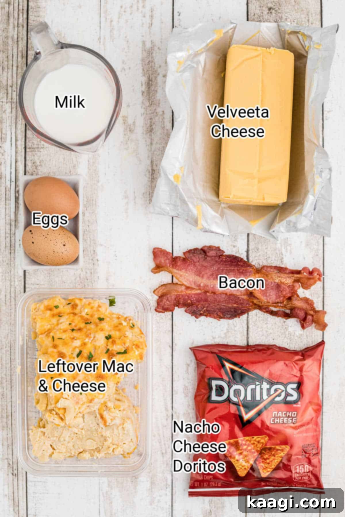 Crispy Air Fryer Mac & Cheese Poppers 3 A neatly arranged collection of ingredients for making Air Fryer Mac n cheese bites, including mac and cheese, bacon, Velveeta, Doritos, eggs, and milk on a wooden surface.