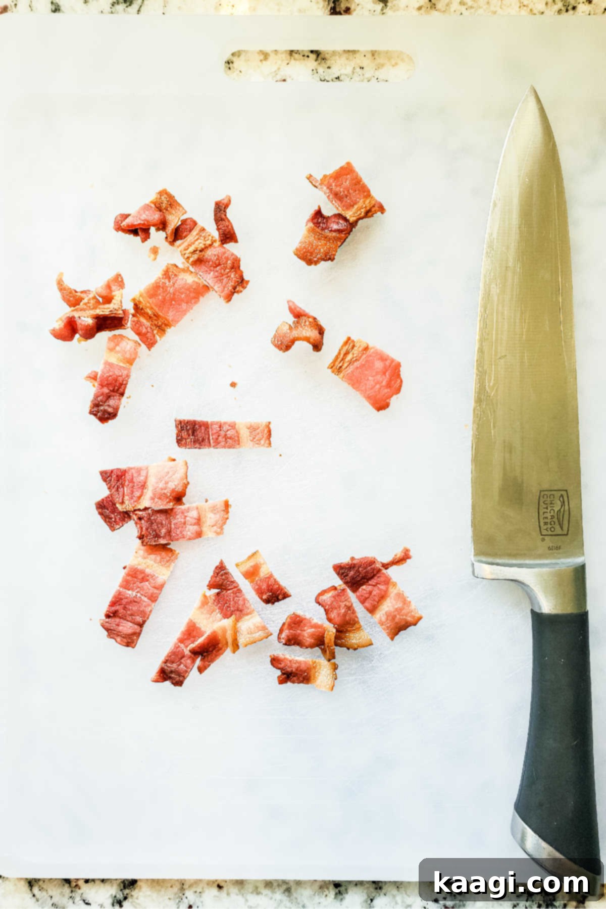 Crispy Air Fryer Mac & Cheese Poppers 4 Crispy bacon bits neatly chopped on a wooden chopping board, ready to be incorporated into the mac and cheese bites.