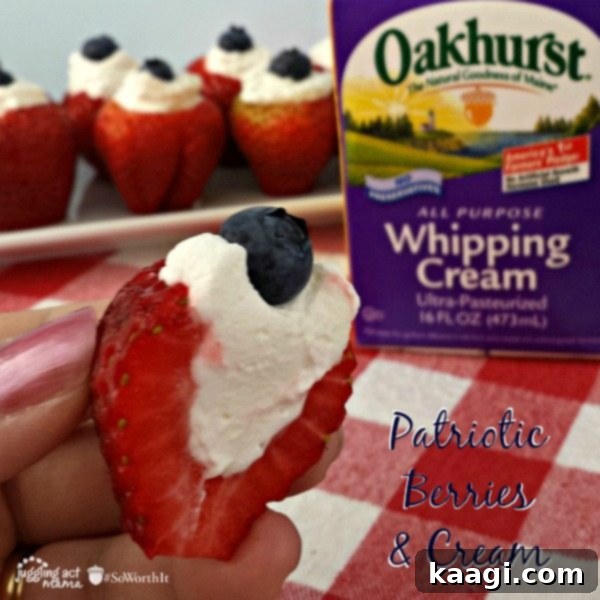 Patriotic Berries and Cream, served in a clear glass with layers of red strawberries, white cream, and blue blueberries.